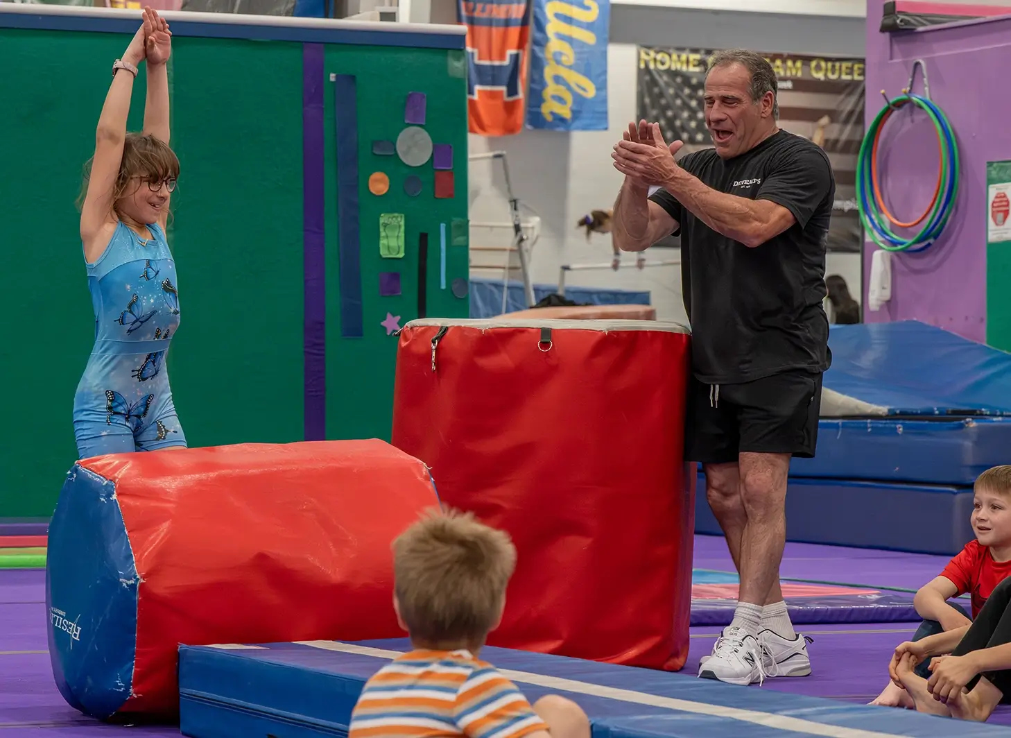 DeVeau's coach celebrating a gymnastics student