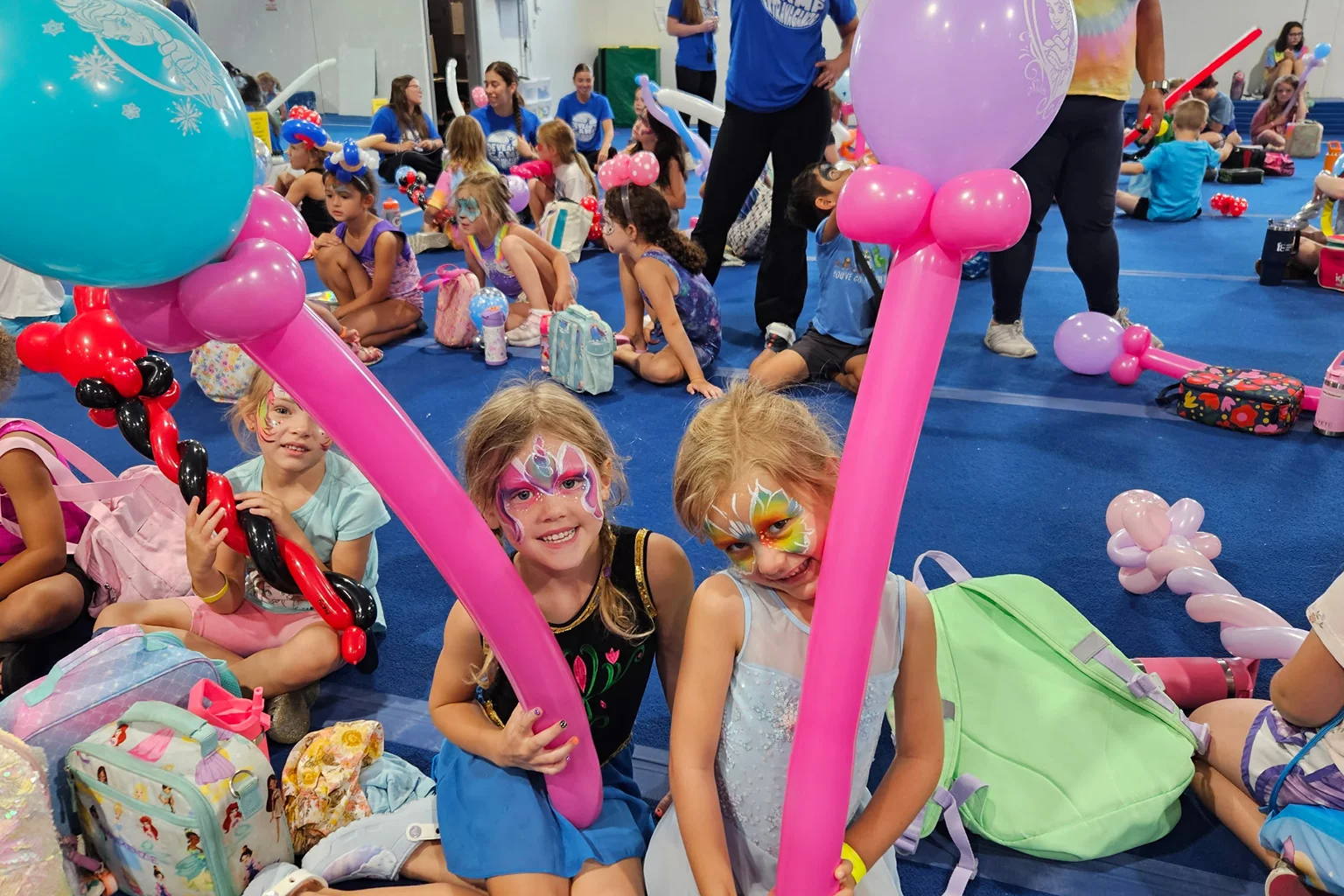 Girls at DeVeaus Camp with balloons and face paint