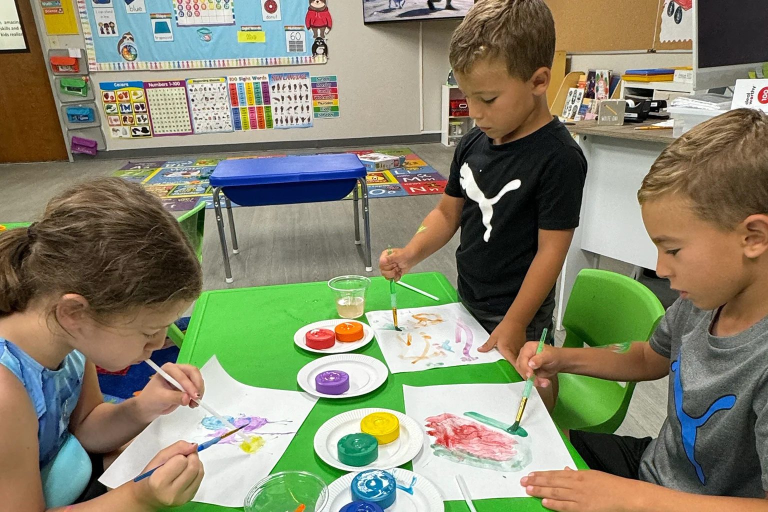 Group of kids painting at Parents Night Out